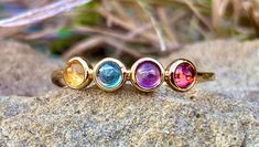 Dainty, minimalist, mult-color, multi natural 3mm, 4 different gemstones, gemstones:Amethyst, Garnet, Topaz, and Citrine, set in 14K gold plated over 925 sterling silver. 1mm band width. Multicolor Amethyst Birthstone Ring, Multicolor Multi-stone Amethyst Ring, Topaz And Citrine, Bloodstone Necklace, Chrysoprase Ring, Lapis Lazuli Pendant, Garnet Rings, Multi Stone, Birthstone Ring