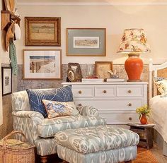 a living room filled with furniture and pictures on the wall next to a bed in a bedroom