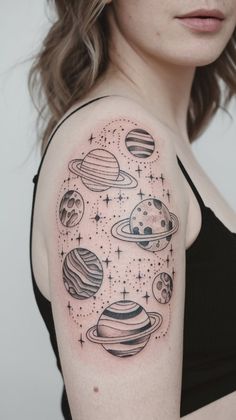 a woman with a tattoo on her arm that has planets and stars all over it