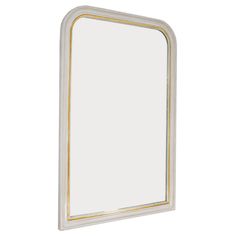 a white mirror with gold trim on the edge and an oval shaped frame around it