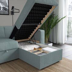 a blue couch with an open storage compartment