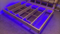 a bed frame with blue lights on it