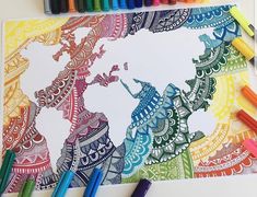 the world map is drawn with colored markers and crayons on top of it