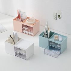 three boxes with various items in them sitting on a white counter top next to each other