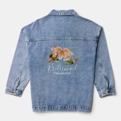 a denim jacket with embroidered flowers on the back