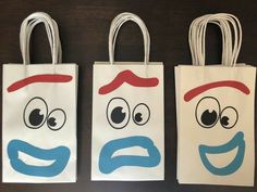 three bags with faces painted on them