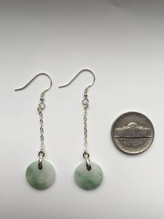 This pair of long dangle & drop earrings are made of quality Chinese coin shaped green & white jade drops and 925 Sterling silver hooks and wire. The fine green & white jade are icy and natural. The jade is carved into a Chinese antique & vintage coin shape. All metals parts are sterling silver. The simple designs with long dangle donut & round shaped jade drops demonstrate elegance and contemporariness. Some highlights of this pair of graceful Chinese jade earrings are: *Hig Jade Drop Earrings With Ear Wire, Jade Dangle Earrings For Pierced Ears, Nickel-free Round Jade Earrings, Pierced Jade Dangle Earrings, Hypoallergenic Dangle Jade Earrings, Hypoallergenic Jade Dangle Earrings, Hypoallergenic Round Jade Earrings, Jade Dangle Earrings, Chinese Jade Jewelry