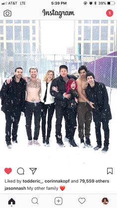 a group of people standing together in the snow with their arms around each other and smiling at the camera