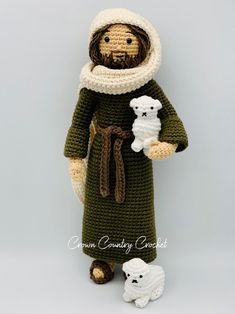 a crocheted jesus holding two white teddy bears