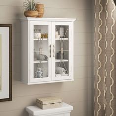 a white cabinet sitting next to a window