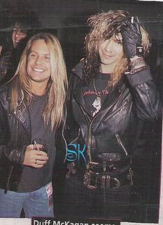 two women standing next to each other wearing leather jackets