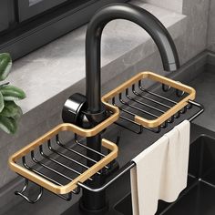 two black and gold sink faucets with towels hanging from them