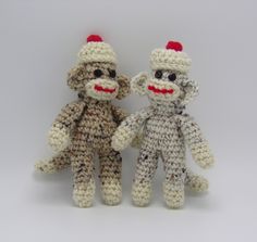 two crocheted stuffed monkeys sitting next to each other