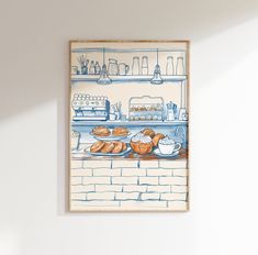 a painting on the wall of a kitchen with breads and coffee cups in front of it