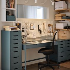 a desk with several drawers and a chair in front of it, next to a book shelf