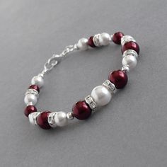 I have paired dark red and white glass pearls with crystal bands to create this burgundy pearl bracelet. The lustrous pearls and sparkling crystals make this garnet pearl and crystal bracelet the ideal gift for bridesmaids in a claret themed wedding. These bordeaux single strand bracelets measure 7 inches / 17.75cm in length and are finished with a silver plated lobster clasp. I have added a 1 inch extension chain to allow you to adjust your marsala pearl bracelet to fit. All of my jewellery pie Chunky Stone Necklace, Chunky Pearl Necklace, Pearl Drop Pendant, Fused Glass Necklace, White Bridesmaid, Felt Necklace, Gift For Bridesmaids, Jewelry King, White Pearl Bracelet