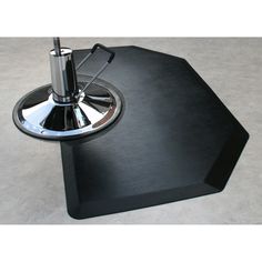 a black table with an umbrella on it in the middle of a flooring area