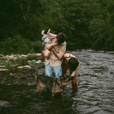 three people and a dog are in the water