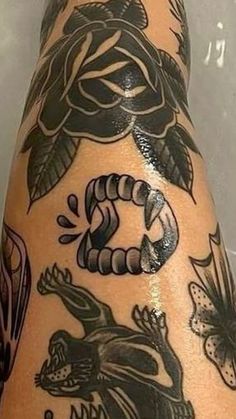 an arm with some tattoos on it