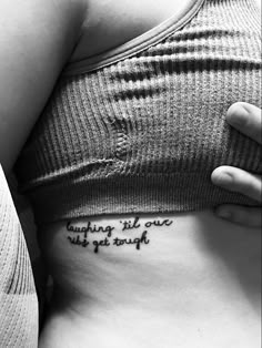 a woman's stomach with the words, anything is over will get tough written on it