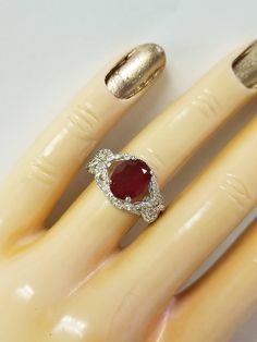 "Thanks for shopping our vintage estate store. We tend to sell well below wholesale and truly hope you enjoy all of our items. Many of the items are one of a kind, so please enjoy scrolling through the pictures and hopefully something will catch your eye. Black spots are from reflections. Nice estate sterling silver 925 red ruby cz diamonds ring. This is a custom made ring from our shop, meaning we added the gem to the setting. Ring size: please select a size Setting: 5/8\" 12mm Band width: 2mm Dazzling Oval Ruby Ring For Anniversary, Collectible Oval Ruby Ring In Silver, Collectible Oval Ruby Ring With Diamonds, Oval Ruby Ring With Diamond For Collectors, Oval Ruby Ring With Cubic Zirconia For Anniversary, Gifts For Work Colleagues, Clean Rings, Diamond Cocktail Ring, Dog Earrings