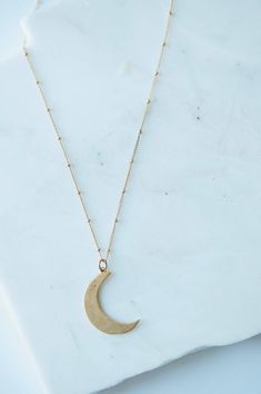 Sliver Moon Charm Necklace on delicate ball + curb chain Gold plated charm and chain Pendant: 1″ Chain length: 16″ Dainty Metal Necklace With Moon Charm, Everyday Crescent Moon Phase Charm Necklace, Minimalist Metal Moon Charm Necklace, Everyday Brass Necklace With Moon Charm, Everyday Half Moon Charm Necklace, Minimalist Nickel Free Moon Necklaces, Minimalist Moon Shaped Nickel Free Necklaces, Everyday Moon Charm Necklaces, Minimalist Nickel-free Moon Necklace