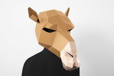 an animal mask made out of paper with the face of a horse wearing a black shirt