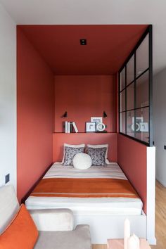 an orange and white bedroom with a bed