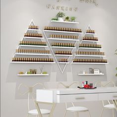 a white table topped with two chairs next to a shelf filled with bottles and plants