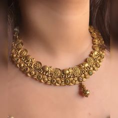 Very gorgeous and elegant matt gold jewellery embedded with reddish pink and green stones Includes necklace and earrings Goes perfectly with sarees and any formal or semi formal clothing. Perfect for wedding occasions. Premium quality and craftsmanship  Necklace length 14-16 inches with an adjustable golden dori at the back Each earring weighs 10 gms  Earrings: Pushback Dual-tone Temple Necklace Chandbali For Wedding, Dual-tone Kundan Temple Necklace For Wedding, Dual-tone Temple Necklace For Wedding And Festive Occasions, Festive Dual-tone Temple Necklace For Wedding, Traditional Brass Choker For Wedding, Gold Temple Jewelry Choker With Zari Work, Elegant Gold Choker With Zari Work, Dual-tone Temple Necklace For Wedding And Diwali, Gold Choker With Zari Work For Festivals