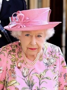 the queen of england is wearing a pink hat