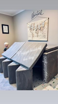 a child's playroom with three stools and a map on the wall