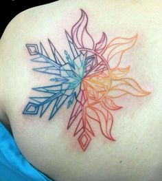 the back of a woman's shoulder with an abstract tattoo design on it