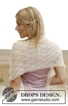 a woman wearing a white shawl in the desert