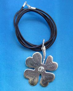 a black leather cord with a silver cross on it