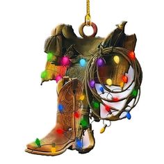 a cowboy boot ornament hanging from a chain with christmas lights on the boots