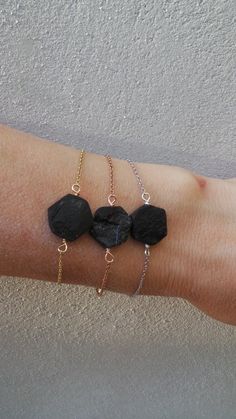 Before placing an order please check the estimated shipping times. If you need your order in a hurry shipping upgrades are available. Thank you. Raw black tourmaline is combined with a delicate chain to create this lovely protection bracelet. D E T A I L S *Made with a raw tourmaline stone cut in a hexagonal shape. *This has been wire wrapped to a dainty 14k stainless steel chain. Silver and rose gold are also available. *Stainless steel does not tarnish or oxidise and is also amazingly hypoalle Black Bracelet With Adjustable Chain For Everyday, Adjustable Black Spinel Jewelry For Gifts, Black Tourmaline Jewelry With Natural Stones, Black Adjustable Chain Bracelet Gift, Black Adjustable Chain Bracelet As A Gift, Black Tourmaline Jewelry As Gift, Black Tourmaline Jewelry Gift, Dainty Black Bracelet For Gift, Black Tourmaline Bracelet