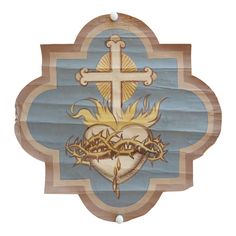 a wooden sign with a cross and crown of thorns on it, in the shape of a heart