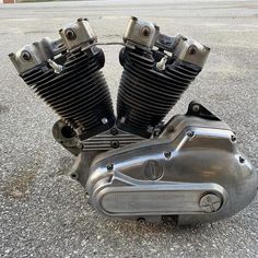 an old motorcycle engine sitting on the ground