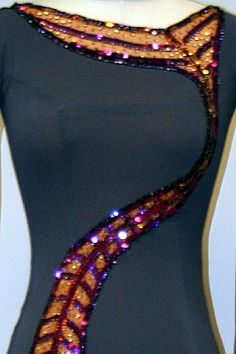 a mannequin wearing a black dress with colorful sequins on it's neck