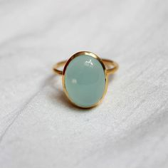 D E T A I L S - Material:  Sterling silver 925Stone:      Aqua ChalcedonyThe fit:     True to US ring size Finish:      Smooth and Gold Plated to a high shineS H I P P I N G & P R O D U C T I O N - My current production time is 2-6 business days, which means after those days are up, your order ships! I make everything custom to order, by hand, but I promise you it's worth the wait!R U S H - M Y - O R D E R -If you're in a rush to get your pretty new pieces, please send me a message and I'll Yellow Gold Chalcedony Ring Gift, Chalcedony Rings Fine Jewelry For Gift, Elegant Chalcedony Rings For Gift, Classic Chalcedony Ring Jewelry, Oval Chalcedony Rings Fine Jewelry, Classic Chalcedony Rings As Gift, Oval Chalcedony Wedding Rings, Handmade Chalcedony Rings For Anniversary, Anniversary Chalcedony Ring With Polished Finish