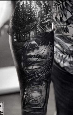 a man's leg with a black and white photo on it that is covered in tattoos