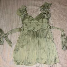 “Silk-Like” Mint Green Baby Doll Dress With Ruffle Sleeves And Tie Back. Never Been Worn. Purchased From Highland Park Boutique. Spring Silk Mini Dress With Ruffles, Green Sleeveless Evening Blouse, Flowy Sleeveless Blouse For Party, Flowy Sleeveless Party Blouse, Green Flowy Mini Dress For Evening, Flowy Green Mini Dress For Evening, Spring Silk Mini Dress With V-neck, Dressy Silk Mini Dress For Summer, Silk Flowy Party Blouse