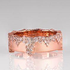 a rose gold ring with diamonds on it