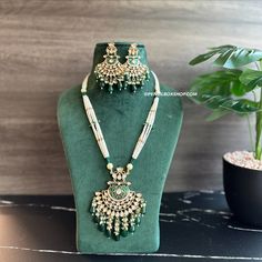 22k gold plated Green Enamel meena work Pearl Long Tayani Necklace set. Experience elegance and tradition with our 22k gold plated Green Enamel meena work Pearl Long Tayani Necklace set. The intricate meena work adds a touch of luxury, while the long tayani design exudes sophistication. Elevate any outfit with the timeless beauty of pearl and gold. American Diamond Necklaces, Oxidized Necklace, Polki Necklace, Western Earrings, Ethnic Necklaces, Ethnic Earrings, Kundan Necklaces, American Diamond, Green Enamel