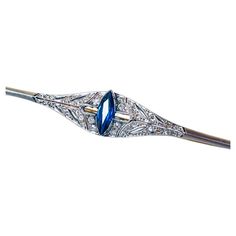 A stylish Art Deco brooch pin in platinum topped 18K yellow gold set with diamonds and marquise cut natural medium blue sapphire. The brooch comes with the box shown in the photo. Item specifications: platinum-topped 18K yellow gold tested; 28 rose cut and 8 eight cut diamonds at approx. 0.80ct TW; 1 natural medium blue sapphire; 10 x 4 mm, approx. 0.80ct; it measures 1.2 x 6.5 cm and weighs 6.8gr; the condition is very good. Sapphire Brooch, Art Deco Brooch, Stylish Art, Yellow Gold Setting, Marquise Cut, Gold Set, Gold Platinum, Rose Cut, Medium Blue