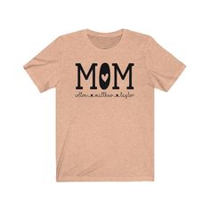 "DESCRIPTION Super cute, unisex shirt with the word, \"Mom\" and kid's names below with adorable hearts. Great t-shirt for a Mom birthday gift, Mother's Day gift, baby shower gift, or a New Mom gift. Please leave personalization information of all the kid's names to put under the word Mom. We will put 2-4 names per line depending on the size of the names. As needed, some names will go on a 2nd line or even a 3rd if there are a lot of names. CARE INSTRUCTIONS Design is professionally transferred Bride Squad Shirt, Aunt Birthday Gift, Aunt Birthday, Lyric Shirts, Aunt Shirt, New Aunt, Aunt Shirts, Kids Names, Bella Canvas Tees