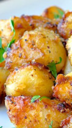 fried potatoes with herbs on a white plate