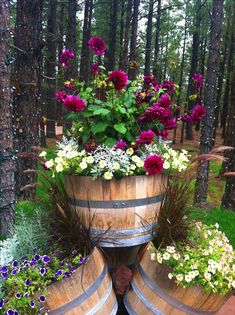 a wooden barrel filled with lots of flowers