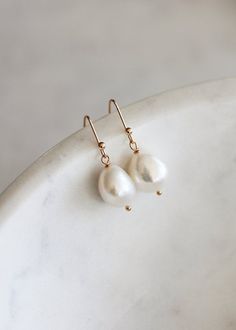 The ultimate pearl drop for minimalist brides, the Lara earrings feature luminous freshwater pearls that are striking in their simplicity and timeless in their silhouette.Available in silver or gold tones. Please leave your colour preference in the message box at checkout.• DETAILS •> Designed in Australia. Worldwide shipping> Silver or gold plated findings, freshwater pearls> Dimensions: 26mm length (11-12mm pearl)> Colour: Silver or gold tones• READY TO SHIP •The Lara earrings are ready to shi Timeless Drop Earrings For Bridal, Timeless Drop Bridal Earrings For Wedding, Timeless Wedding Drop Earrings, Delicate White Pear-shaped Bridal Earrings, Minimalist Dangle Teardrop Earrings For Wedding, Minimalist Teardrop Dangle Earrings For Wedding, Minimalist Drop Earrings For Wedding, Timeless Dangle Bridal Earrings For Wedding, Timeless Teardrop Bridal Earrings For Wedding